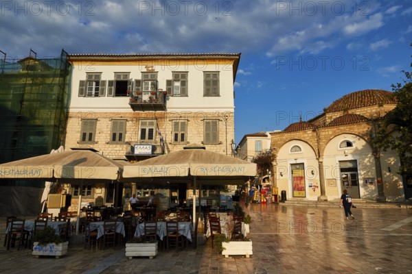 Old town of Nauplion, an empty square with cafés and historic buildings in mild morning light, Nauplion, Nafplion, Peloponnese, Greece