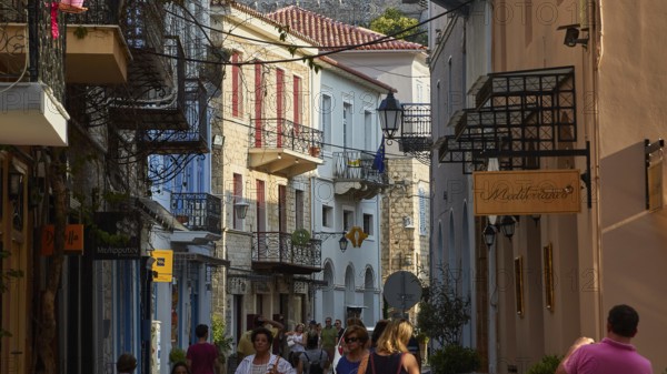 Old town of Nauplion, busy old town street with people, surrounded by historic houses and balconies, Nauplion, Nafplion, Peloponnese, Greece