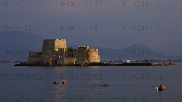 Bourtzi island fortress, rocky fortress on a small island in sunset light, Nauplion, Nafplion, Peloponnese, Greece