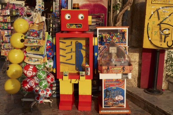 Old town of Nauplion, A colorful robotic toy machine next to yellow balloons at a street stand, Nauplion, Nafplion, Peloponnese, Greece