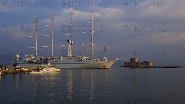 Port of Nauplion, Bourtzi island fortress, A large sailing ship in the harbor next to smaller boats and a fortress, Nauplion, Nafplion, Peloponnese, Greece