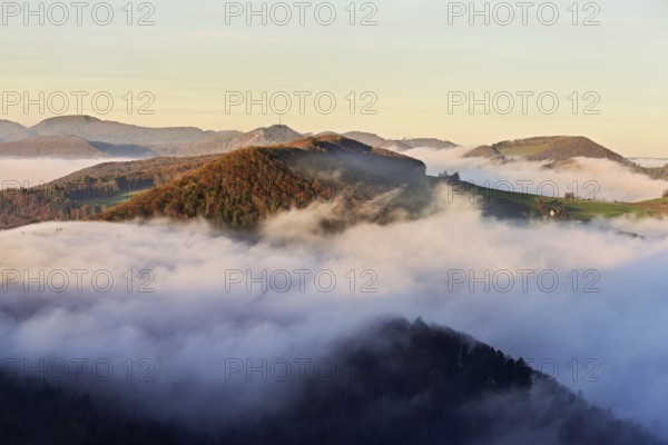 View from the Gisliflue of the Jurassic foothills covered in fog from the left, Wasserfluh, Summerholde, Asperstrihen, in the light of the rising sun, Talheim, Canton of Aargau, Switzerland