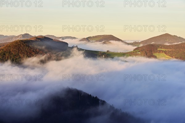 View from the Gisliflue of the Jurassic foothills covered in fog from the left, Wasserfluh, Summerholde, Asperstrihen, Strihen, in the light of the rising sun, Talheim, Canton of Aargau, Switzerland