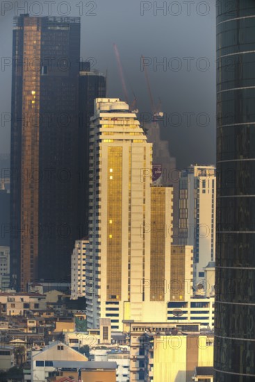 Panorama from the Iconsiam viewing platform of skyscrapers of the Bangrak banking district at sunset, skyline of Bangkok, Thailand