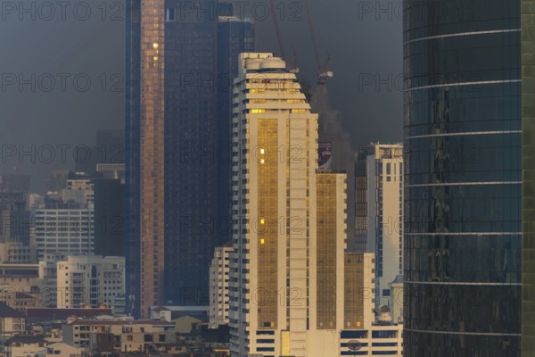 Panorama from the Iconsiam viewing platform of skyscrapers of the Bangrak banking district at sunset, skyline of Bangkok, Thailand