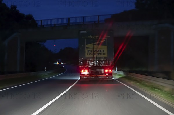 Braking truck on federal road at night, Schleswig-Holstein, Germany