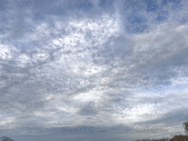 Extensive cloud cover with large layer of altostratus clouds with bag-shaped bulges at the bottom in the background gray dark bad weather cloud Nimbostratus, international