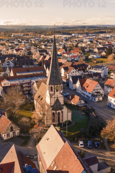 Panoramic view of a village with church and traditional houses in autumn surroundings, Althengstett, Calw district, Germany