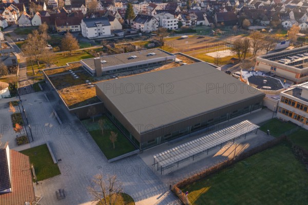 Aerial view of a large, modern building complex with sports facilities and surrounding parking spaces, sports center and swimming pool Althengstett, Calw district, Germany