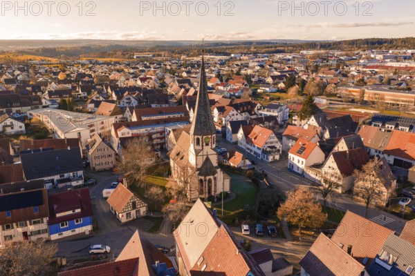Bird's eye view of a village with a distinctive church tower and surrounding settlement in autumn, Althengstett, Calw district, Germany