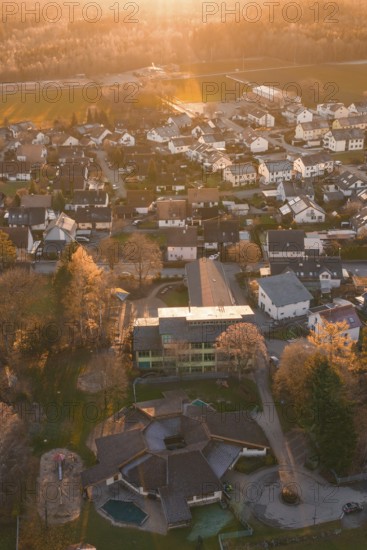 View of residential area from the air with autumn trees and sunset atmosphere, Althengstett, Calw district, Germany