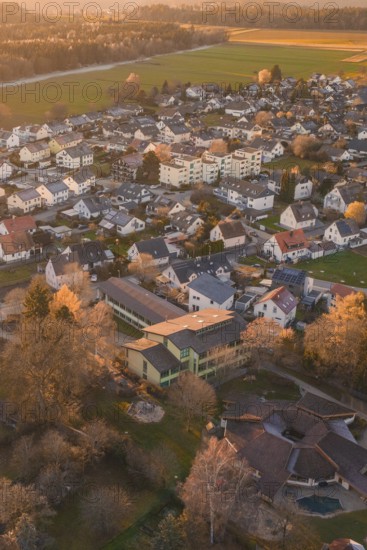 Residential area with many houses and trees seen from above in autumn sunlight, Althengstett, Calw district, Germany