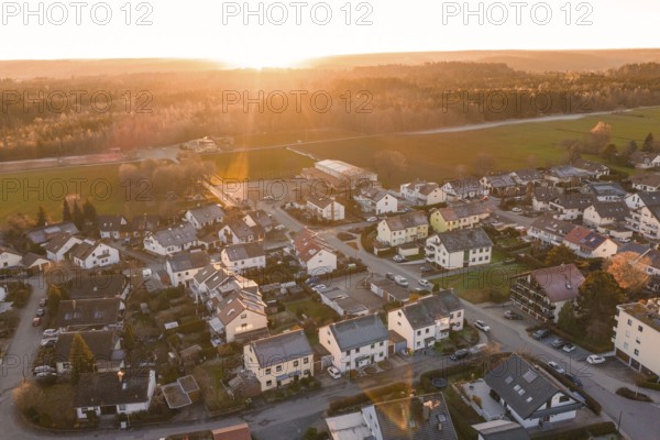 Aerial view of a suburb at sunset with numerous houses and roads, Althengstett, Calw district, Germany