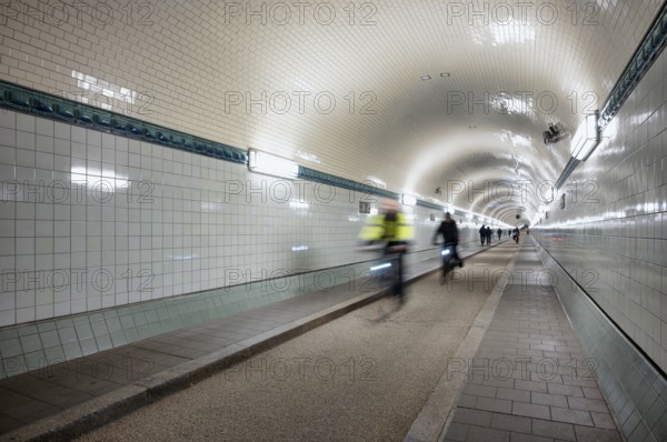 Interior view, pedestrians and cyclists crossing tunnel, mopping effect, movement, tube, historic old Elbe Tunnel, Free and Hanseatic City of Hamburg, Germany