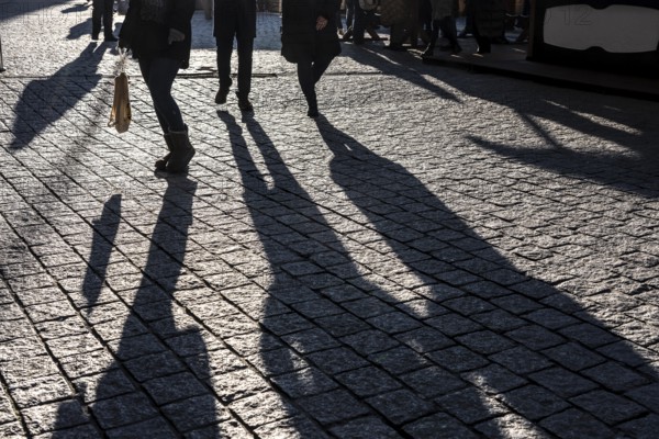 Shadows of people on the ground, low sun, winter, silhouettes, Germany