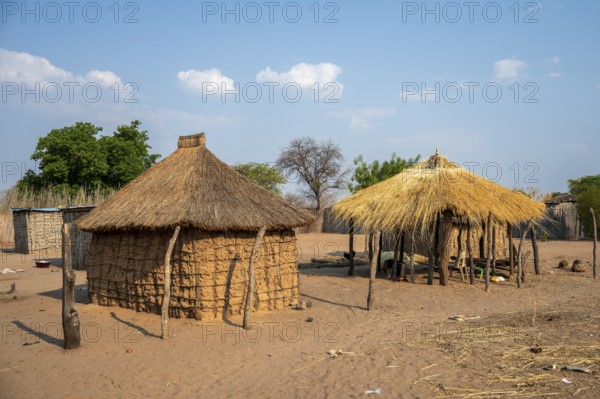 Locals in a typical village with clay huts, Caprivi Strip, Namibia