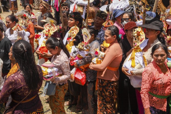 People dressed festively at a cremation ceremony (Ngaben), Ubud, Bali, Indonesia