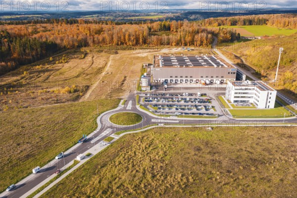 Industrial complex with roundabout, surrounded by forest and empty fields in an autumn environment, new Lindenrain industrial park, Calw, Black Forest, Germany