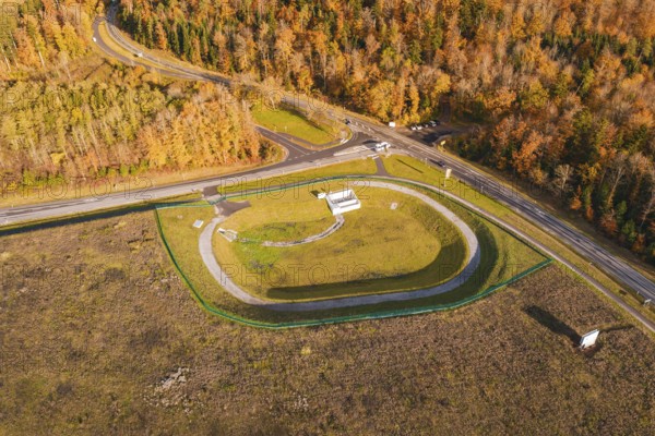 Test site with surrounding forest and road junction in autumn landscape, new Lindenrain industrial park, Calw, Black Forest, Germany