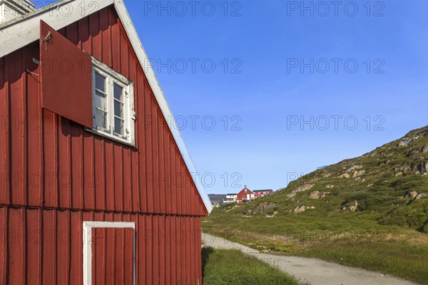 Typical architecture of Greenland Ilulissat with colored houses located near fjords and icebergs