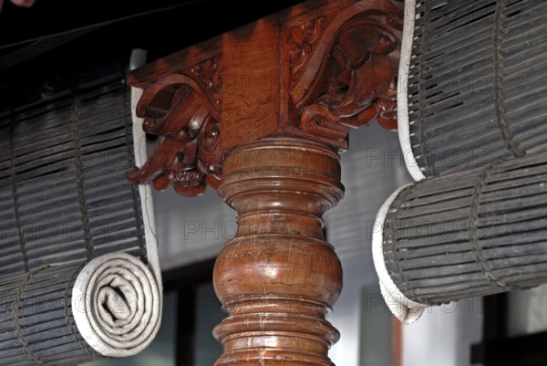 Close-up view of rolled bamboo blinds and artfully turned wooden post, Heritage Hotel Privacy, Vembanad Lake, Kerala, India