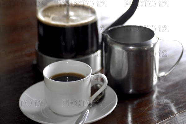 French coffee press next to a cup of coffee and a milk jug on a table, Serenity boutique hotel, Malabar Escapes, Kerala, India