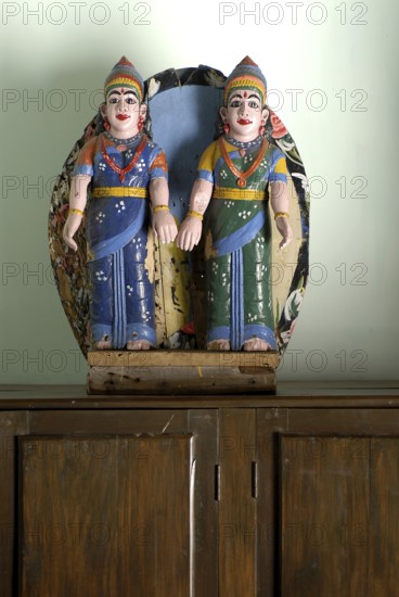 Two painted wooden female figures in traditional South Indian clothing, sari, standing on a closet, Serenity boutique hotel, Malabar Escapes, Kerala, India