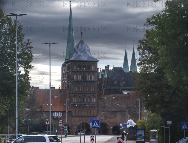 Burgtor, tower of the historic Castel Gate in brick architecture, church towers in the back, Hanseatic City of LÃ¼beck, Schleswig-Holstein, Germany