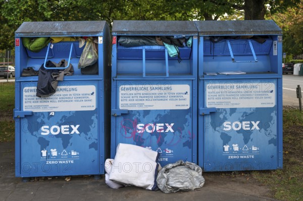 Overcrowded clothing containers in a parking lot, Hanseatic City of LÃ¼beck, Schleswig-Holstein, Germany