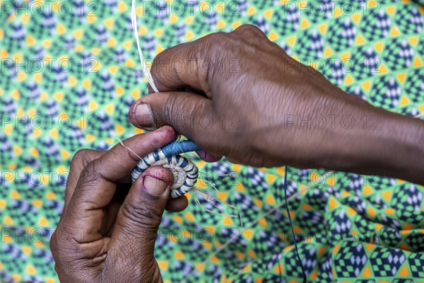 Local woman weaving baskets from papyrus, near Fort Portal, Uganda