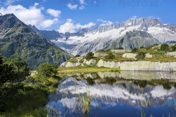 Picturesque mountain landscape, dammastock and damma glaciers reflected in Moorsee, GÃ¶scheneralp, Canton of Uri, Switzerland