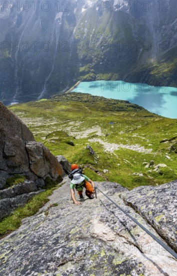 Mountaineer climbs on the secured Schijen-ZwÃ¤rg via ferrata, climb to BergseehÃ¼tte, Göscheneralp in the back, Canton of Uri, Switzerland