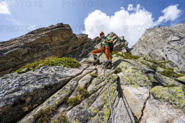 Mountaineers on the secure via ferrata Crocodile Mountain Lake at Bergseeschijen-Vorbau, Göscheneralp, Canton of Uri, Switzerland