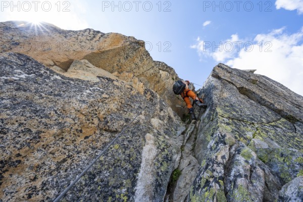 Mountaineers on steep rock face in the secured via ferrata Crocodile Mountain Lake at Bergseeschijen-Vorbau, Sonnenstern, Göscheneralp, Canton of Uri, Switzerland