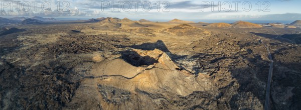 VolcÃ¡n de Las Nueces volcano, picturesque volcanic landscape with volcanic craters and lava fields in morning light, Parque Natural de Los Volcanes, aerial view, Lanzarote, Canary Islands, Spain