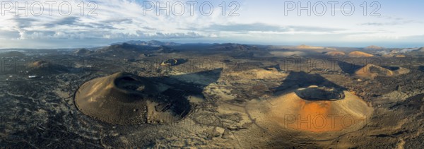 Panorama, MontaÃ±a Negra volcano and Caldera Colorada, picturesque volcanic landscape with volcanic crater in morning light, Parque Natural de Los Volcanes, aerial view, Lanzarote, Canary Islands, Spain