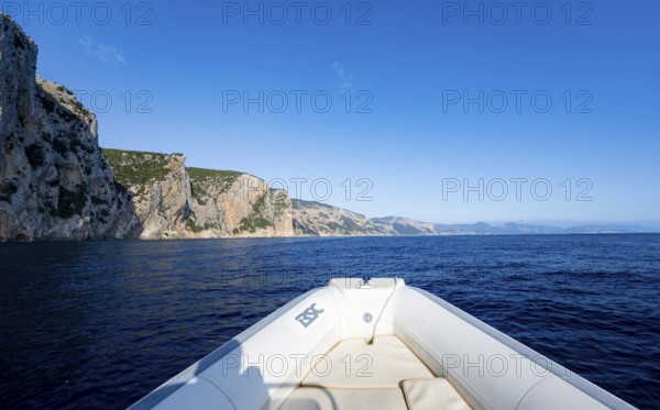Motorboat trip along the picturesque rocky coast, cliffs and blue sea, Golfo di Orosei, Baunei, Sardinia, Italy