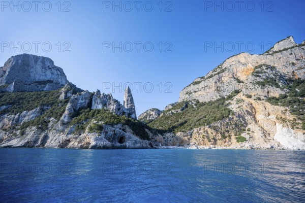 Picturesque rocky coast, cliffs with L'Aguglia pinnacle, blue sea and Cala GoloritzÃ© beach, Golfo di Orosei, Baunei, Sardinia, Italy