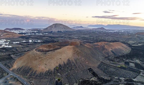 Picturesque volcanic landscape with volcanic craters MontaÃ±a de la Tabaiba at sunrise, Parque Natural de Los Volcanes, aerial view, Lanzarote, Canary Islands, Spain
