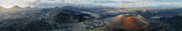 Panorama, Caldera Colorada volcano and MontaÃ±a Negra, picturesque volcanic landscape with volcanic craters at sunrise, Parque Natural de Los Volcanes, aerial view, Lanzarote, Canary Islands, Spain