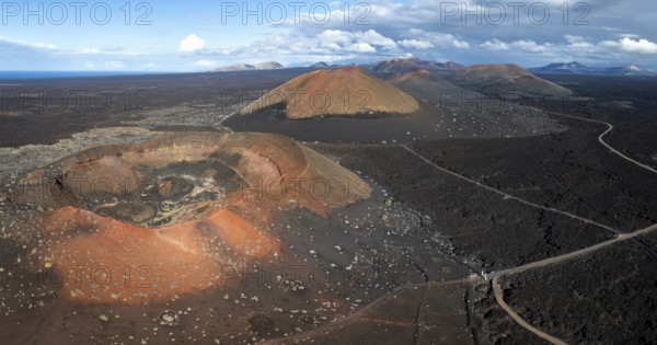 MontaÃ±a Quemada and MontaÃ±a Pedro Perico volcanoes, volcanic landscape with craters and lava fields, aerial view, Lanzarote, Canary Islands, Spain