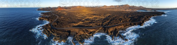 Coast with lava fields, volcanic landscape near Los Hervideros with red volcano MontaÃ±a Bermeja, in the evening light, aerial view, Lanzarote, Canary Islands, Spain
