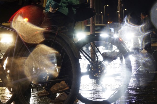 Cyclists in the evening in rainy weather in a city, Germany