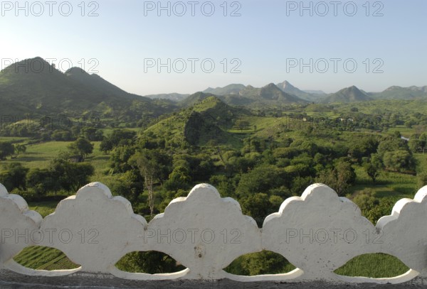 Hilly, green landscape of Aravalli Mountains in monsoon, view from Palace Hotel Devigarh, Delwara village near Udaipur, Rajasthan, India
