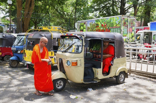 Buddhist monks talking near a tuk-tuk, Kandy, Sri Lanka