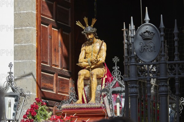 Good Friday procession, Christ statue surrounded by roses in front of a wooden gate, UNESCO World Heritage Old Town of San Crstobal de La Laguna, La Laguna, Tenerife, Canary Islands, Spain