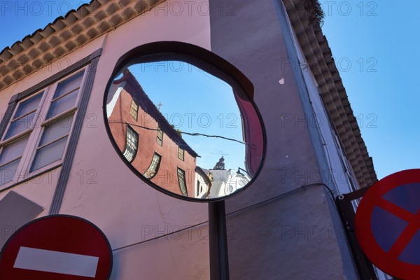 Distorted reflection of houses and road signs in a convex mirror, UNESCO World Heritage Old Town of San Crstobal de La Laguna, La Laguna, Tenerife, Canary Islands, Spain