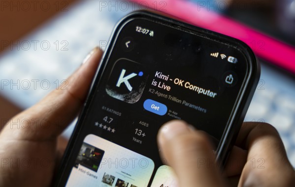 In this photo illustration, a person uses the Kimi AI chatbot on a smartphone, in New Delhi, India on 20 November 2025. Kimi AI is a Chinese artificial intelligence chatbot and assistant developed by Moonshot AI, a fast-growing tech company in China