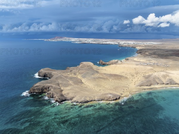 Coast with Playa de Papagayo beach and Playa Caleta del Congrio and blue sea, dry landscape of Los Ajaches Natural Park, aerial view, Lanzarote, Canary Islands, Spain