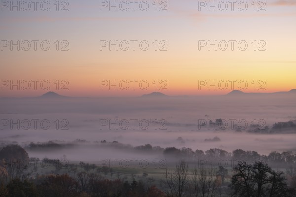 Three Kaiserberge mountains in golden morning light, Hohenstaufen, Aichelberg. Spectacular dawn over the foggy foothills of Baden-WÃ¼rttemberg